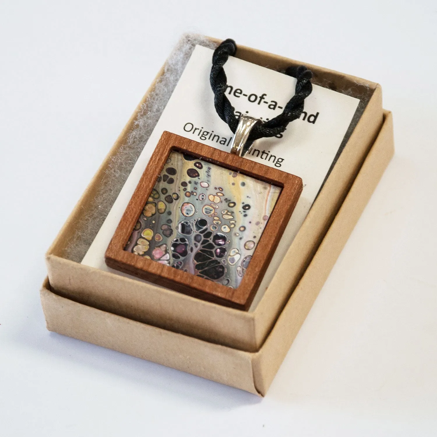 Art Necklace, black and earth tones painting in hardwood frame