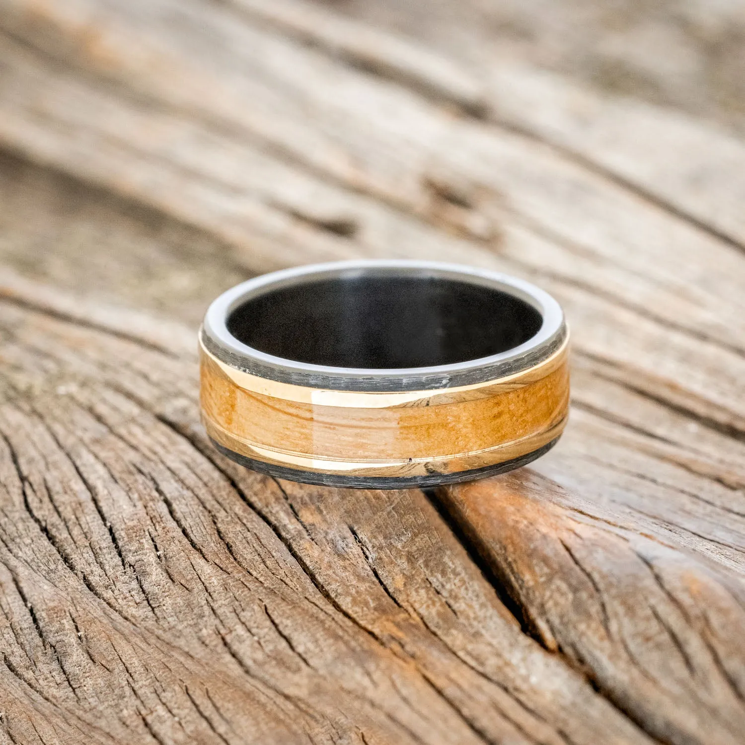 "HOLLIS" - WHISKEY BARREL & 14K YELLOW GOLD INLAYS WEDDING RING FEATURING A HAMMERED BAND - BLACK ZIRCONIUM - SIZE 11